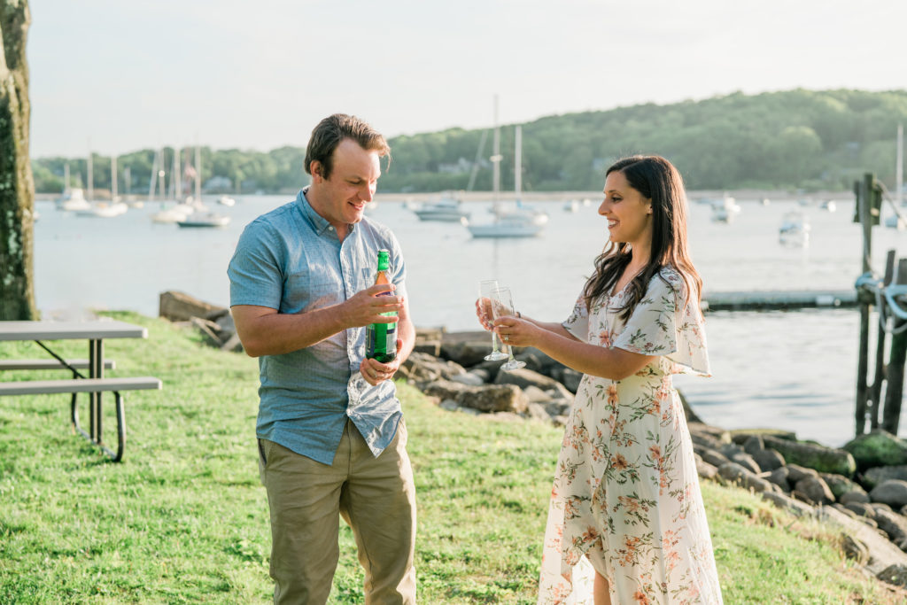 Champagne toast engagement photography Northport Village NY